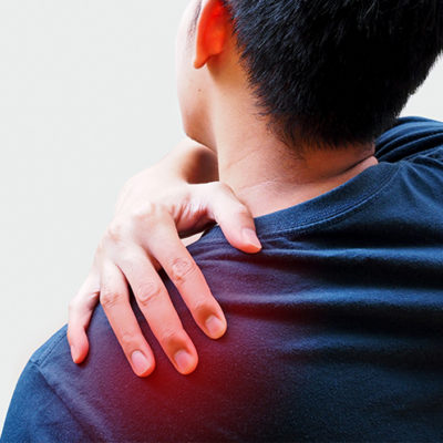 Young Asian man suffering from back pain, shoulder pain and office syndrome.