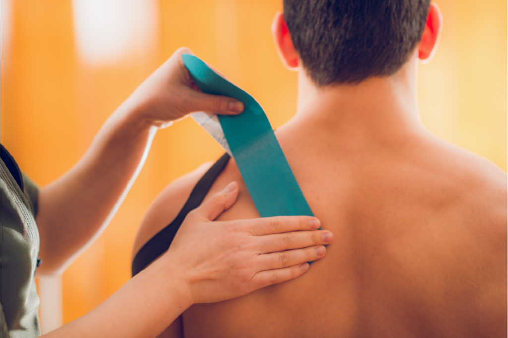 doctor using kinesio taping for shoulder and neck